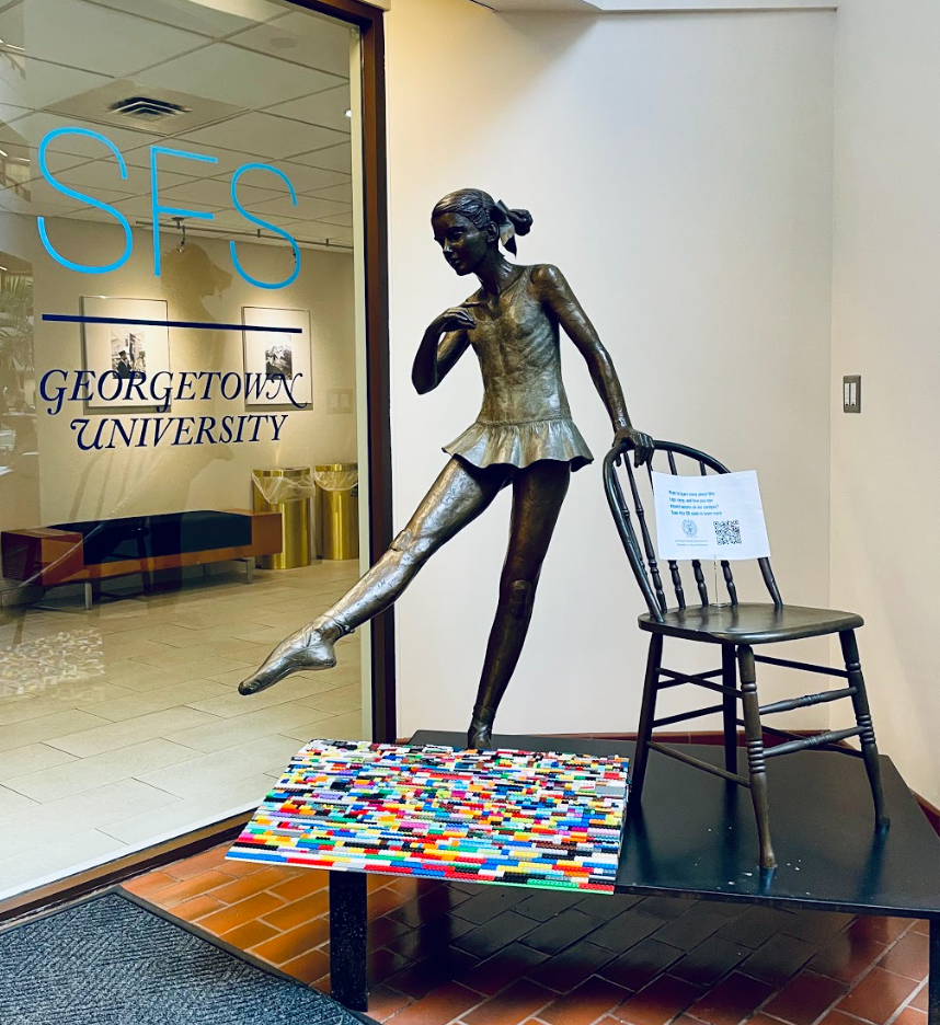 In front of the SFS office, sits the lego ramp pedestaled near a statue of a women posing in ballet holding onto a chair.