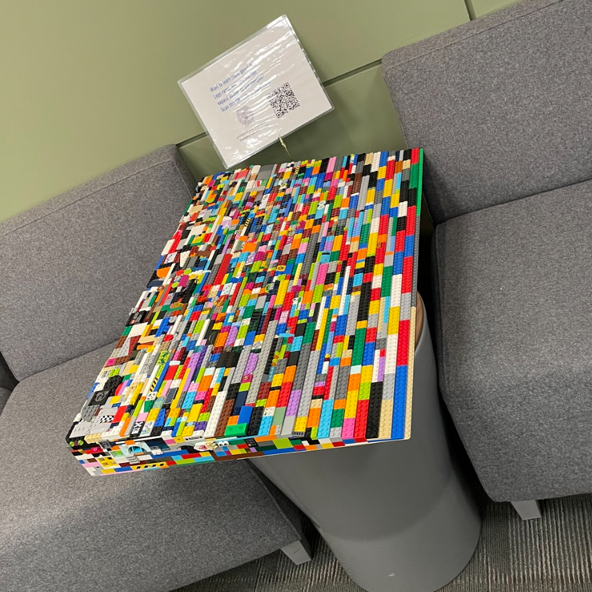 In the Leavey 5 office, sits the lego ramp on a small round table between two grey chairs