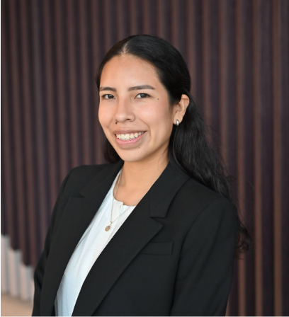Marcia dressed in professional attire, smiling for the camera.