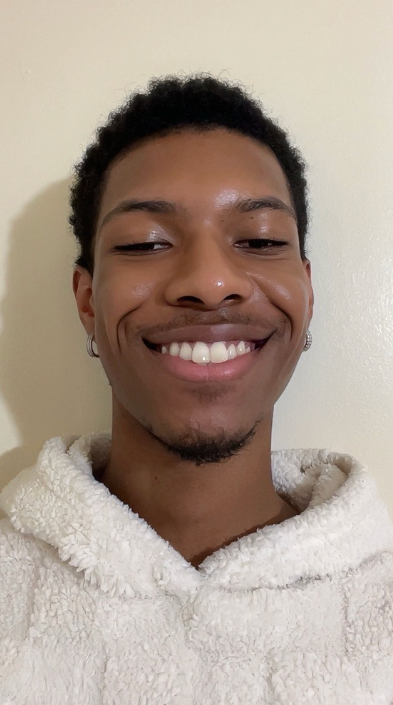 Seven against a white wall, smiling for the camera.